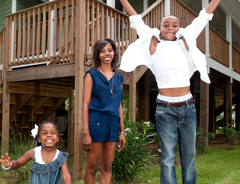 happy family in front of house