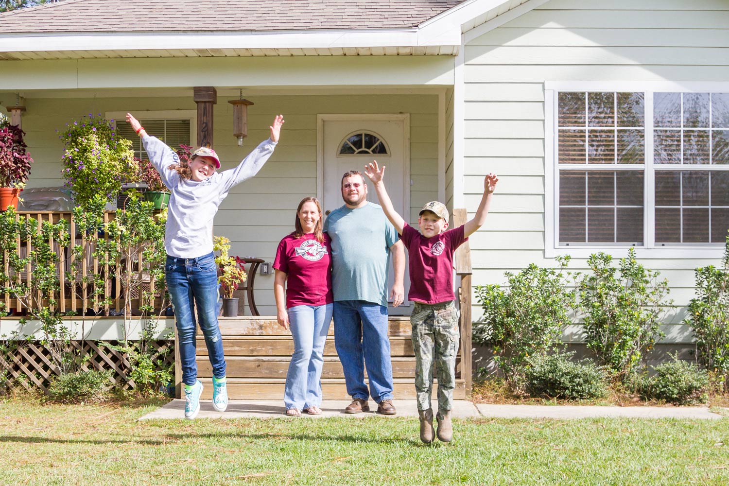 Happy family in front of home